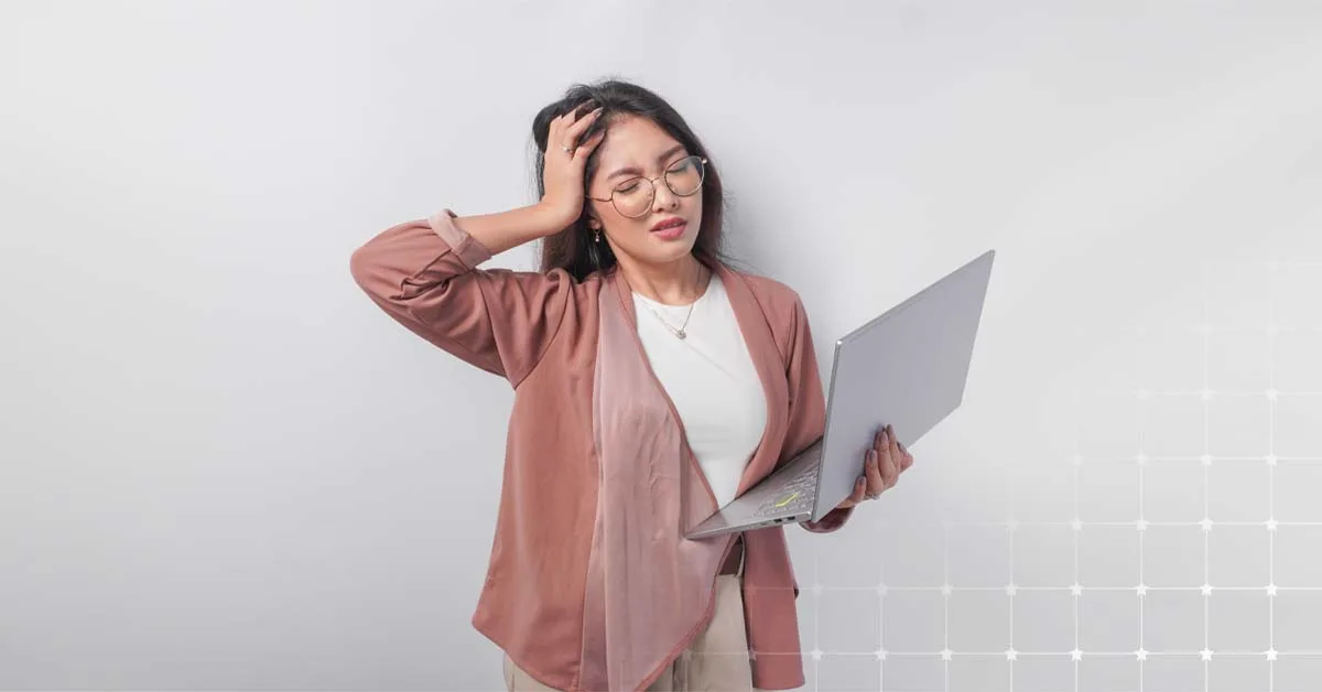 Person experiencing burnout while holding a laptop